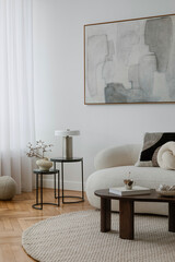 A carefully styled lounge with neutral tones, sculptural forms, and soft furnishings, creating a...