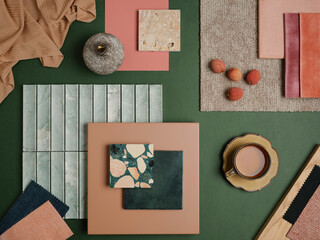  A bold and colorful material arrangement featuring green and pink tones, natural stone, and rich...