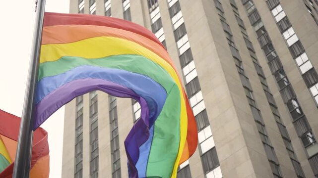 Pride Flag waving against a building in New York