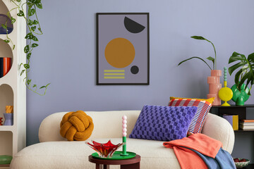 Modern and colorful interior of living room with design boucle sofa, mock up poster, shelf, plants,...