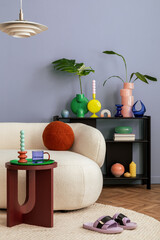Stylish interior of colorful living room with design white sofa, black shelf with vases, book and...