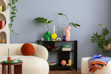 Stylish interior of colorful living room with design white sofa, black shelf with vases, book and personal accessories. Modern home decor. Template