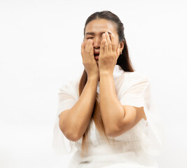 Person Expressing Deep Emotions While Covering Face With Hands in a Bright, Minimalistic Setting