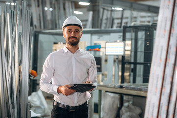 Modern digital tablet. Man is working in the modern factory