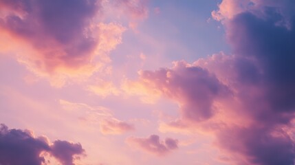 Fototapeta premium Beautiful sunset clouds in a vibrant sky, showcasing colorful hues of pink and purple, perfect for backgrounds and nature-themed designs.
