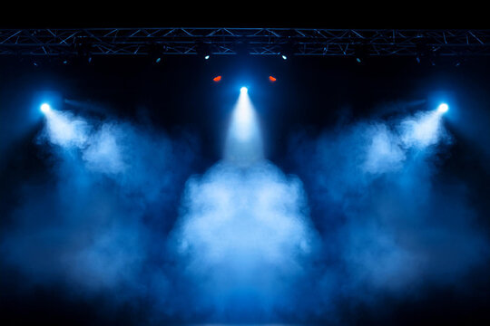 Illuminated stage with scenic blue lights and smoke. Royalty high-quality free best stock image of abstract empty stage with colorful spotlights, display or montage your products - Powered by Adobe