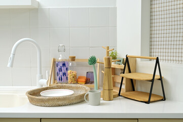 A kitchen sink in a typical home, with various kitchen utensils placed on it	