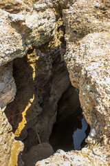 The view of the distant water at the bottom of the narrow Sesriem canyon, in Namibia, as seen from...