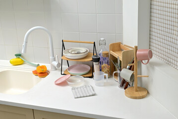 A kitchen sink in a typical home, with various kitchen utensils placed on it