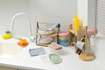 A kitchen sink in a typical home, with various kitchen utensils placed on it
