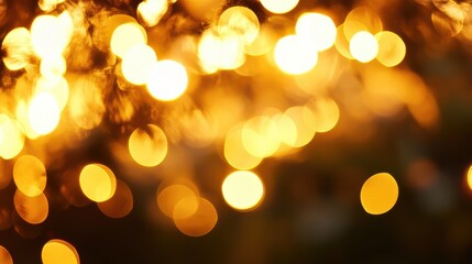 Obraz premium Golden bokeh lights background perfect for holiday decorations, photography, and creative projects. Soft focus sunset glow pattern with warm tones.