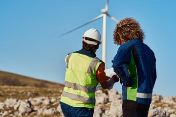 Muslim Woman Engineer and Her Colleague Reviewing a Wind Turbine Project.