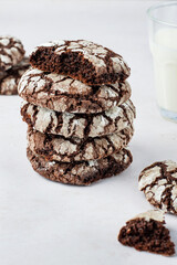 A stack of brownie cookies with milk for breakfast. Close. Traditional American chocolate brownie cookies.