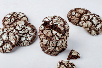 Several chocolate brownie cookies on a light background. Horizontal. Traditional American pastry, chocolate brownie cookies..