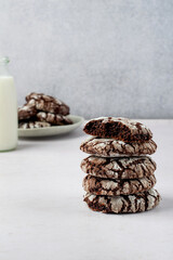 A stack of brownie cookies with milk. Traditional American chocolate brownie cookies..