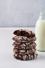 A stack of brownie cookies with milk. Traditional American chocolate brownie cookies..