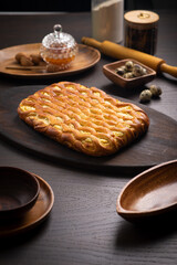 Curd pie on a fluffy ruddy dough on a dark wooden table