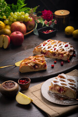 Berry ruddy pie with apples on a dark wooden table