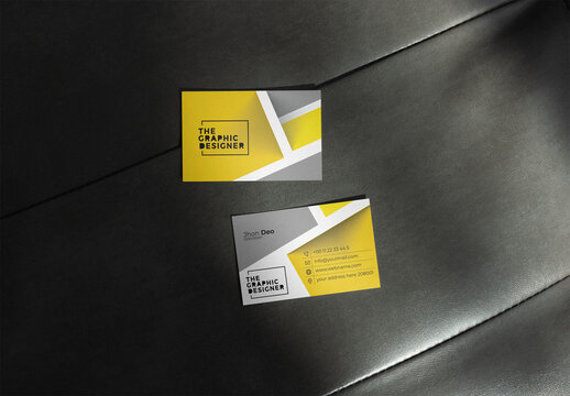Two blank business cards displayed on a dark surface, designed in EU size 85x55 with front and back templates for identity.