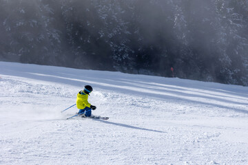Happy family with kids in winter ski resort, skiing winter time