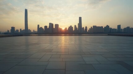 Obraz premium Sunrise over city skyline reflected on empty plaza.