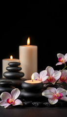 spa and alternative therapy. candles with massage stones and orchid flowers on black background. banner, studio lighting. White tone