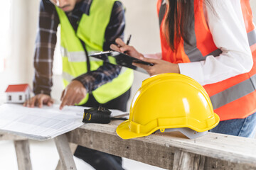 Concept Teamwork of building construction staff. Project engineer contractor reviewing plan of work...