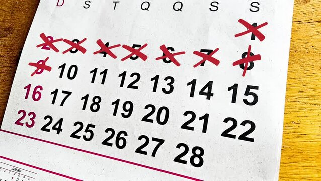 a calendar with all of the days crossed out with a red pen. Concept for busy month, time management, or end of summer. Crossing Out Dates On Calendar