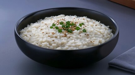 Famous Food of  Korean concept. Creamy rice bowl topped with herbs and spices on a dark background.