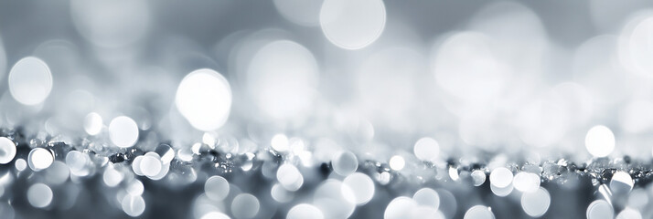 blurry image of a silver surface with many small circles. The image has a dreamy, ethereal quality to it, as if it were a painting or a photograph