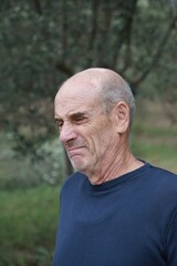 Elderly Bald Man Makes a Gross Face After Eating Bad Food In Nature