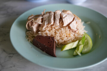Chicken Rice is a traditional Asian dish that perfectly, featuring tender boiled chicken breast and fragrant white rice.