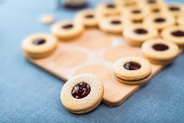 Round shortbread cookies with jam lie on the table