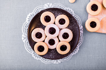 Round shortbread cookies with jam lie on the table