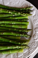 Fresh green asparagus on the wooden rustic board. Healthy vegetarian food concept. Concept of healthy lifestyle. Mediterranean diet. For lunch o barbecue. Spring recipe. 