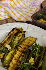 Grilled vegetables for a lunch. Zucchini, asparagus in olive oil with garlic and aromatic herbs. For a barbecue or picnic. Healthy vegetarian food concept. Mediterranean diet.