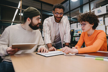 Group of diverse colleagues working on project over table indoors
