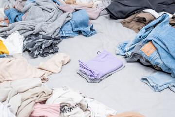 Clothes are haphazardly scattered on the bed