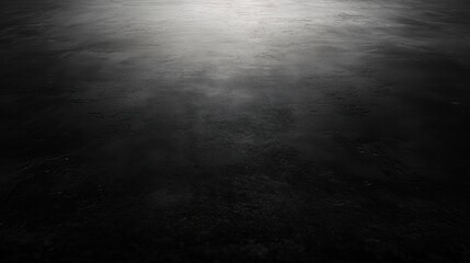 A smooth, dark surface with subtle texture and gradient.