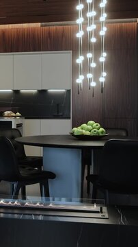 Modern interior design with elegant lighting and black table and chairs . Vertical video