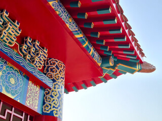 Awning of Chinese shrine. Chinese Roof in the clear sky. Buddha style. © Rungphailin