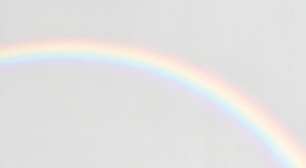 Soft pastel rainbow in a cloudy sky