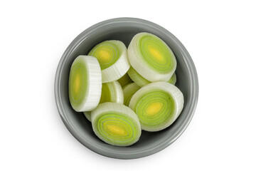 sliced Leek vegetable in ceramic bowl isolated on white background. Top view. Flat lay
