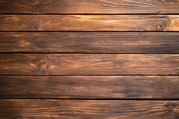 Naklejka premium Rich brown wooden planks create warm and inviting background, perfect for rustic themes and designs. texture and grain add character and depth to any project