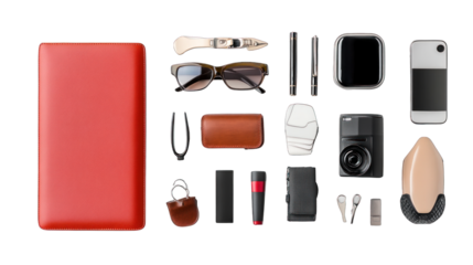 A red leather bound book with a bunch of items on top of it