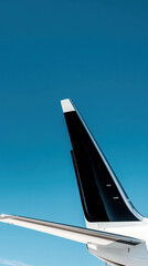 Fototapeta premium Luxury aviation concept featuring a private jet tail against clear blue sky