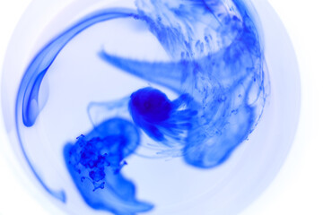 close up of blue paint in water 