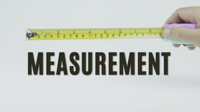 "Measurement" text with a tape measure on a white background, symbolizing precision, accuracy, and sizing in a clean, minimal style