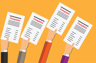 Hands of persons holding a paper with the word complaint