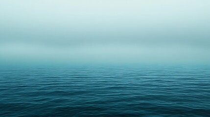 Obraz premium Calm Ocean Water Under Misty Sky